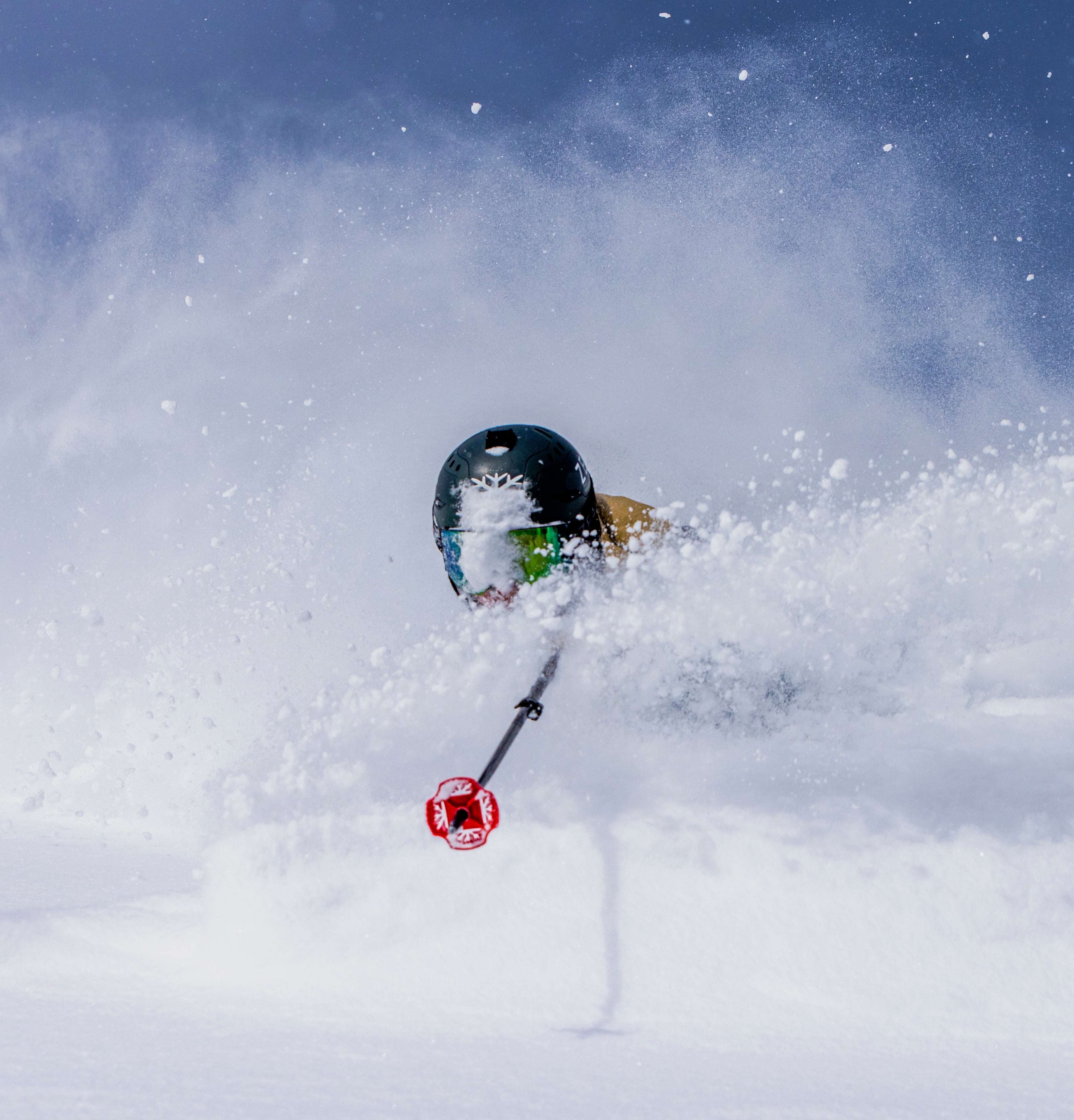 DPS Lotus powder skis floating in deep snow, rider in motion in Utah mountains, lightweight carbon performance.